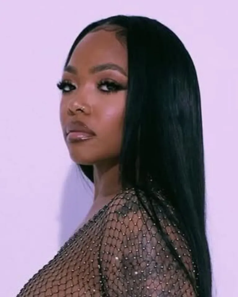 Bone-straight middle-part sew-in, hair provided and installed by Jilluxury